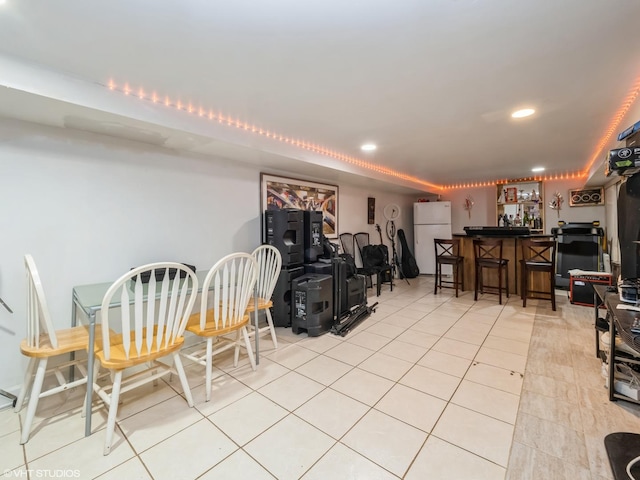 dining room with light tile patterned floors, a dry bar, and recessed lighting