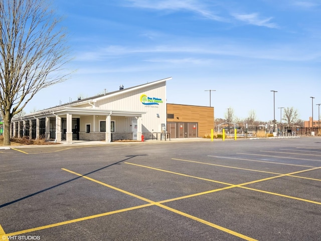 view of building exterior with uncovered parking