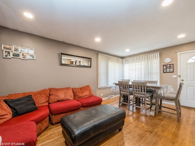 living room with light wood-style floors, recessed lighting, visible vents, and baseboards