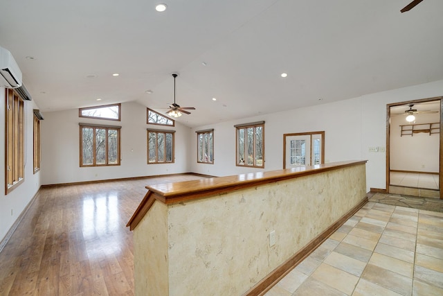 kitchen featuring baseboards, vaulted ceiling, a ceiling fan, and recessed lighting