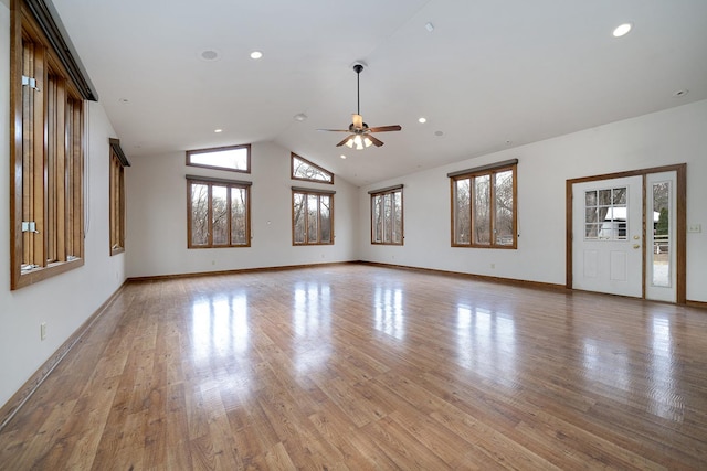 unfurnished living room with ceiling fan, high vaulted ceiling, recessed lighting, baseboards, and light wood-style floors