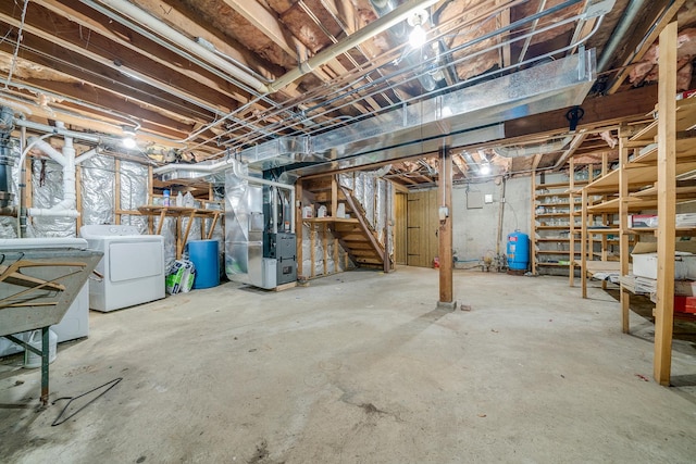 unfinished basement featuring stairway and heating unit