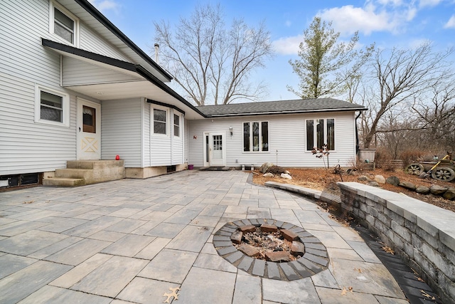 back of property featuring a patio area and an outdoor fire pit