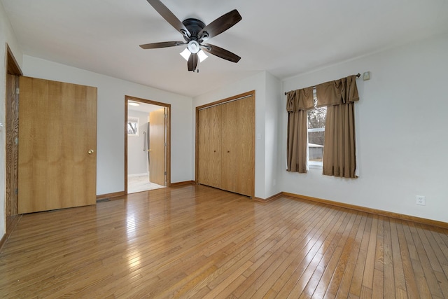 unfurnished bedroom with a closet, light wood-style flooring, and baseboards