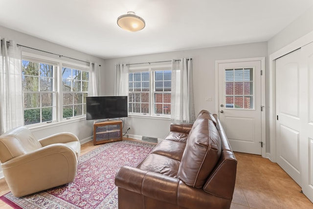 living area with tile patterned flooring and baseboards