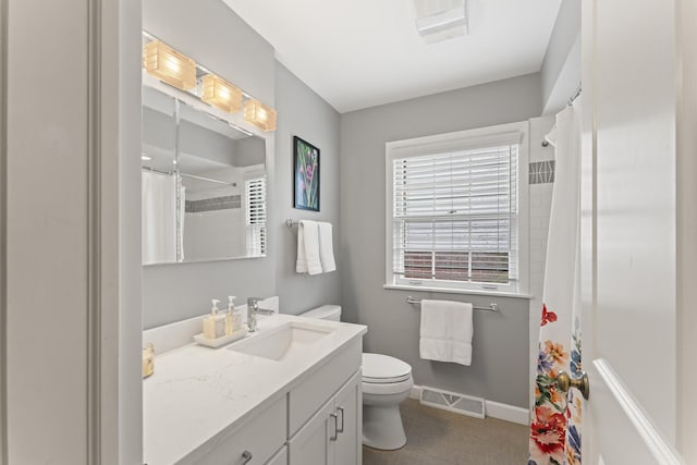 full bathroom with toilet, vanity, visible vents, baseboards, and tile patterned floors