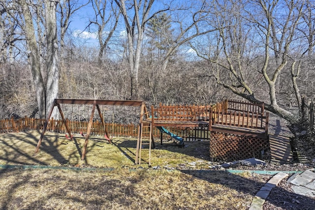 view of yard featuring fence and a playground