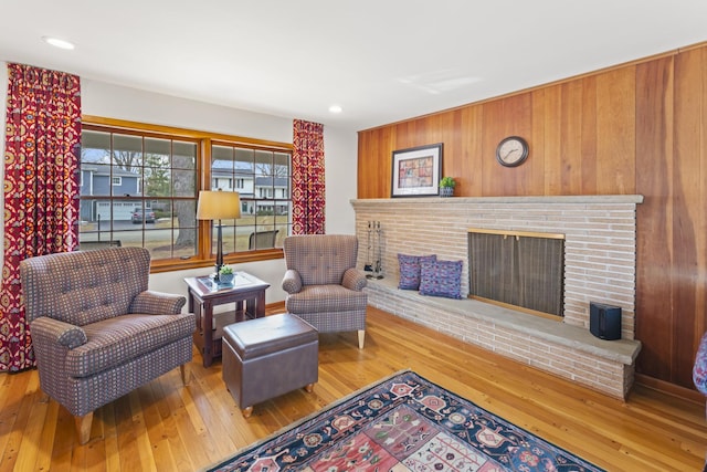 living area featuring hardwood / wood-style flooring, a fireplace, and recessed lighting