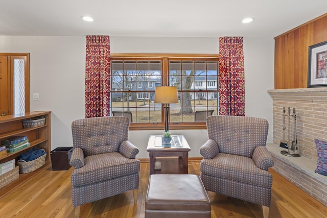 sitting room featuring hardwood / wood-style floors and recessed lighting