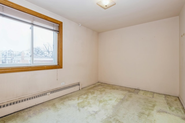 empty room with light carpet and a baseboard radiator