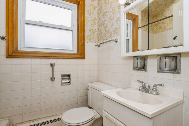 bathroom featuring a baseboard radiator, toilet, a wainscoted wall, vanity, and wallpapered walls