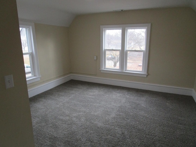 bonus room featuring carpet flooring, vaulted ceiling, and baseboards