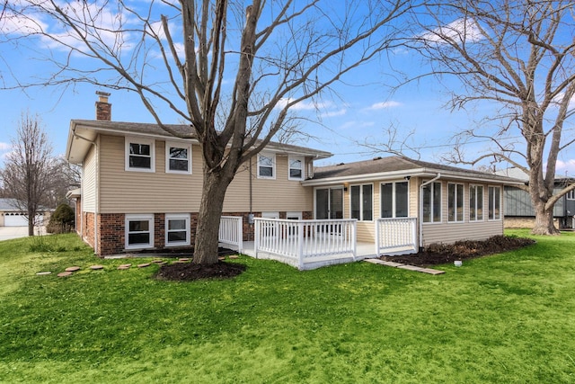 back of house with a sunroom, a chimney, and a yard