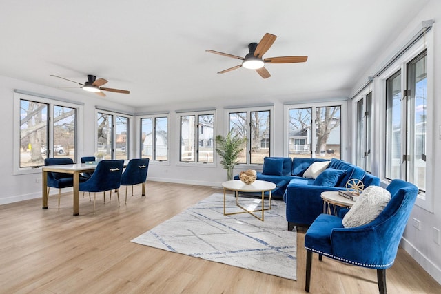 sunroom featuring ceiling fan and a wealth of natural light