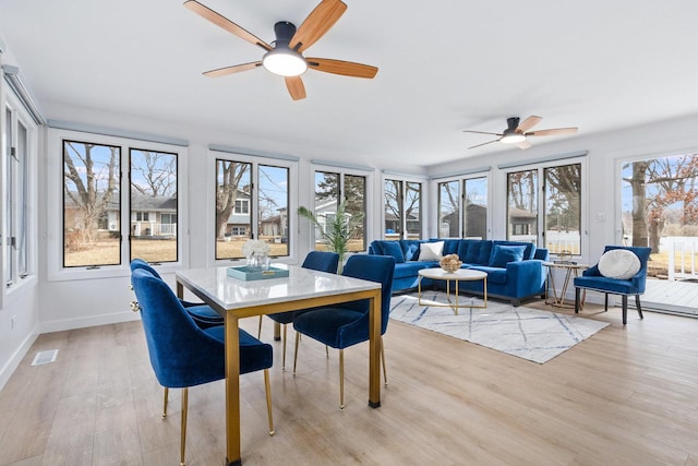 sunroom featuring visible vents and ceiling fan