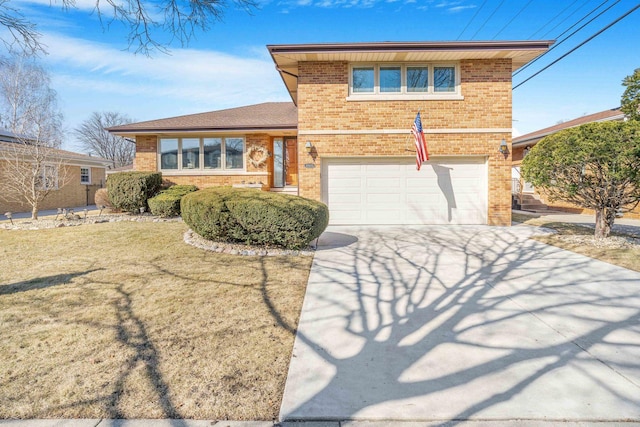 split level home with brick siding, an attached garage, concrete driveway, and a front yard