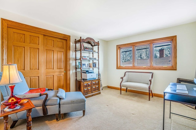 sitting room with baseboards and light carpet