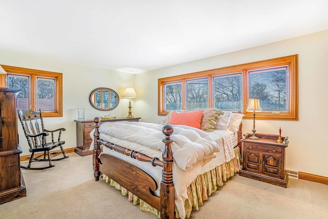 carpeted bedroom with visible vents and baseboards