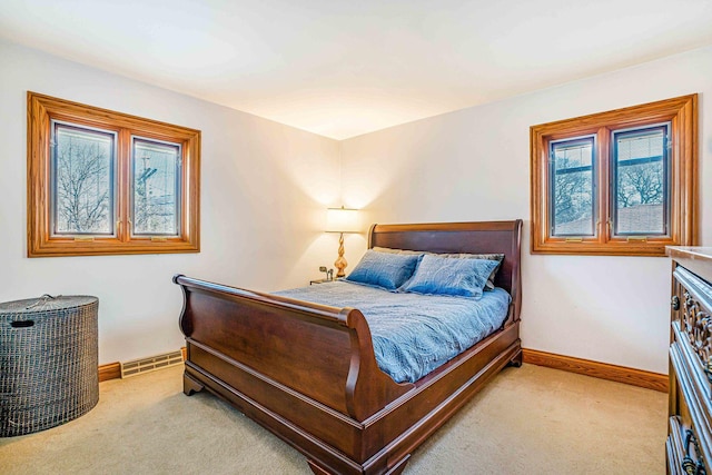 carpeted bedroom with visible vents and baseboards