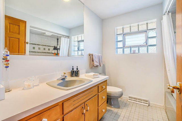 bathroom with tile patterned flooring, visible vents, baseboards, toilet, and vanity