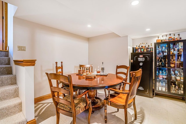 dining space with stairway, recessed lighting, a dry bar, and baseboards