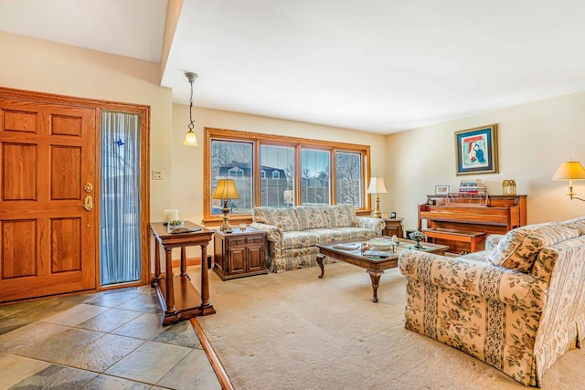 living area with light colored carpet and stone tile floors