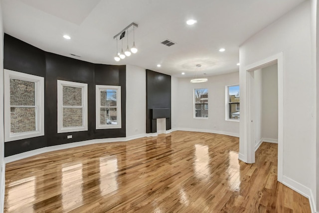 interior space featuring visible vents, baseboards, light wood-style flooring, and recessed lighting