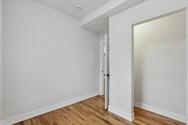 unfurnished bedroom featuring baseboards and light wood-style floors