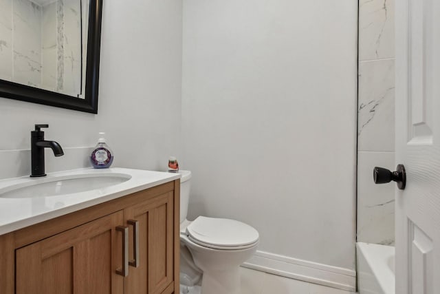 full bathroom with toilet, vanity, and baseboards