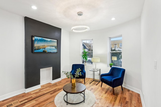 sitting room with light wood-type flooring and baseboards