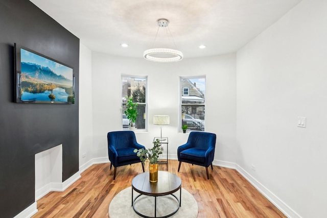 sitting room featuring light wood-type flooring, baseboards, and recessed lighting