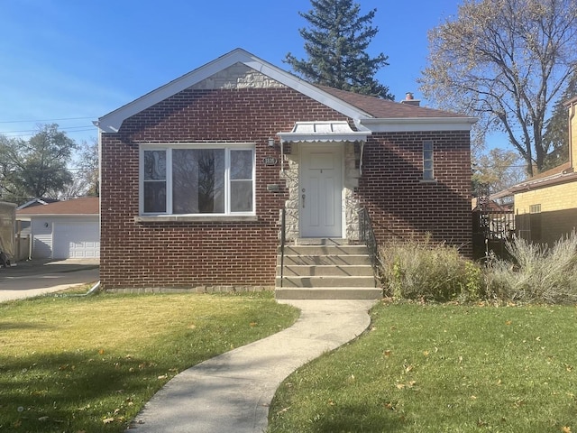 bungalow with a garage, brick siding, a front yard, and an outdoor structure