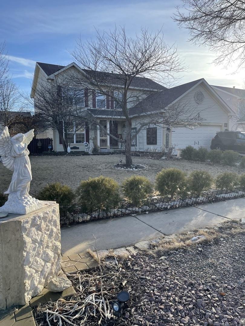 view of front of house with fence and an attached garage