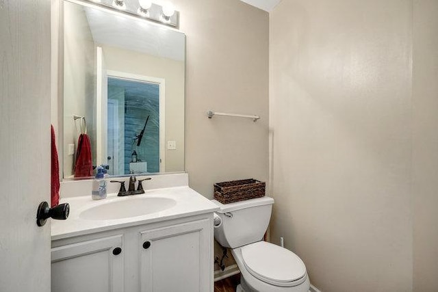 bathroom featuring vanity and toilet