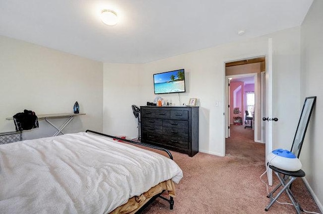 carpeted bedroom featuring baseboards