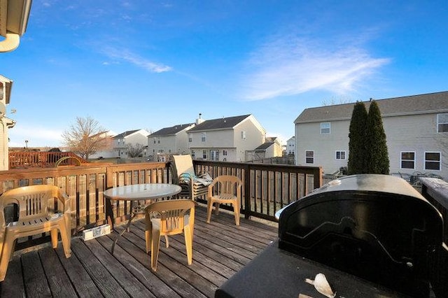 wooden deck with a residential view and area for grilling