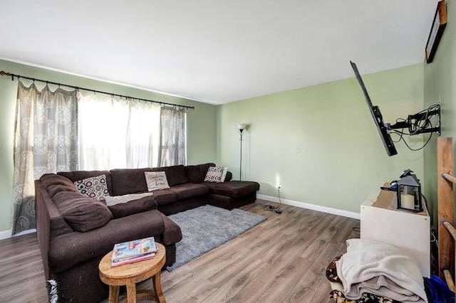 living room featuring baseboards and wood finished floors