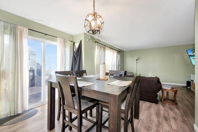 dining space featuring light wood-style floors and baseboards