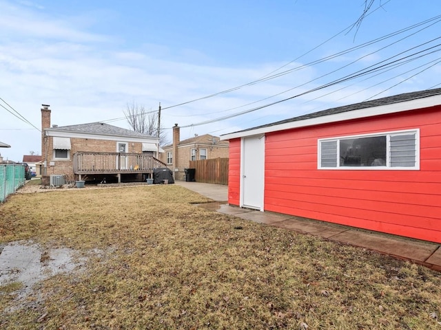 view of yard with cooling unit, fence, and a deck