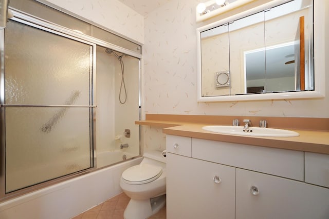 bathroom with wallpapered walls, toilet, enclosed tub / shower combo, tile patterned flooring, and vanity