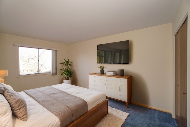 bedroom featuring a closet, carpet flooring, and baseboards