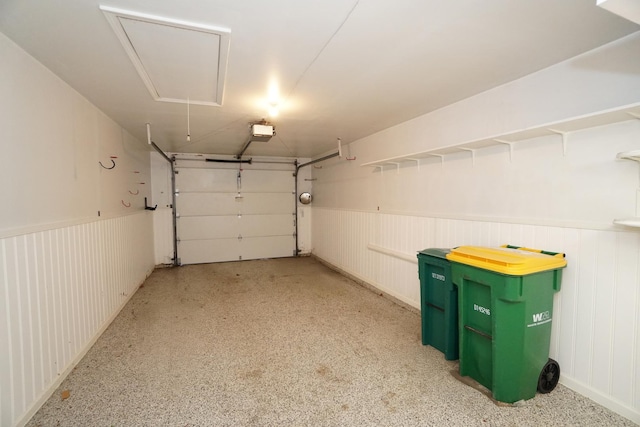 garage featuring a wainscoted wall and a garage door opener