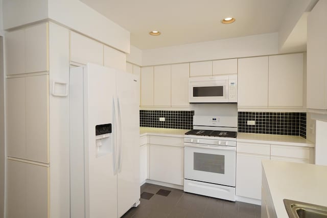 kitchen featuring white appliances, tasteful backsplash, light countertops, and recessed lighting