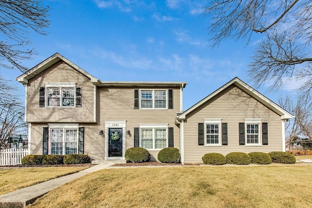 view of front of house featuring a front yard and fence