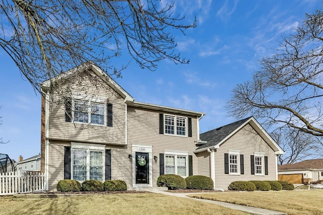 view of front of property with fence and a front yard