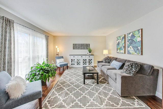 living area with wood finished floors and baseboards