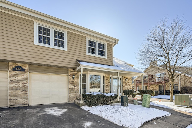 view of front of house featuring a garage and brick siding