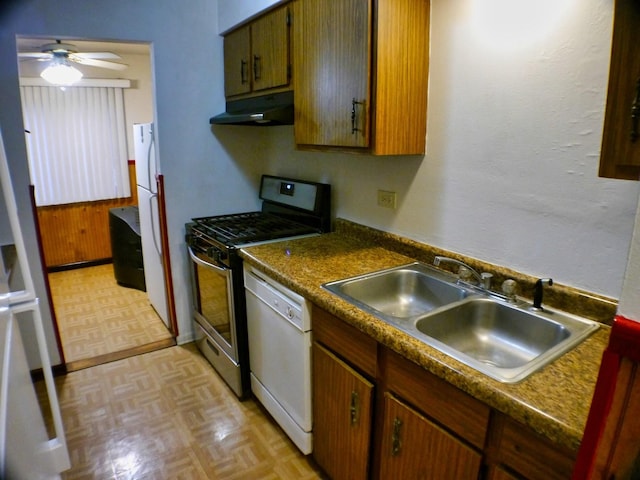 kitchen featuring under cabinet range hood, a ceiling fan, white appliances, and a sink