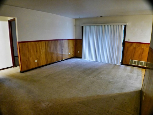 15805 Peggy Ln Unit 2, Oak Forest, IL 60452 - carpeted spare room featuring wood walls, visible vents, and wainscoting