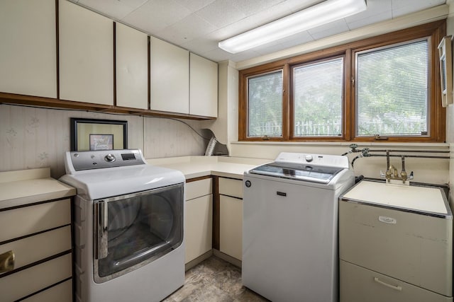 laundry room featuring washer and clothes dryer and cabinet space